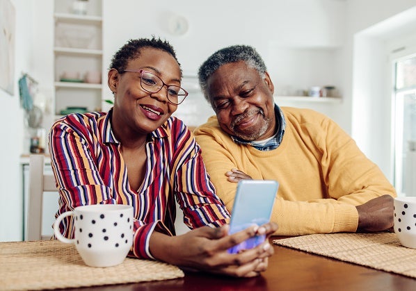 Senior couple using device