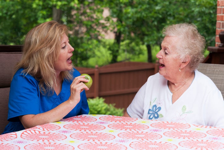 two women talking at a table