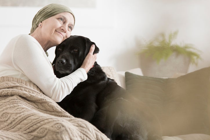 woman in hospice holding dog