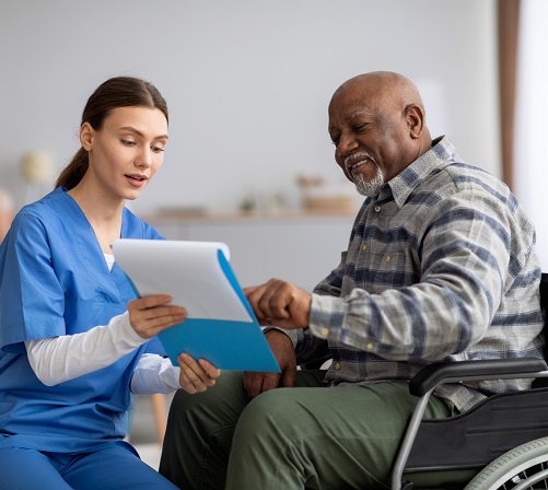 Caregiver helping patient with treatment plan.